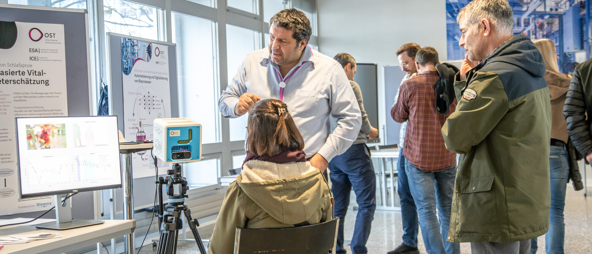 Besucher an der Ausstellung über KI-Projekte der OST.