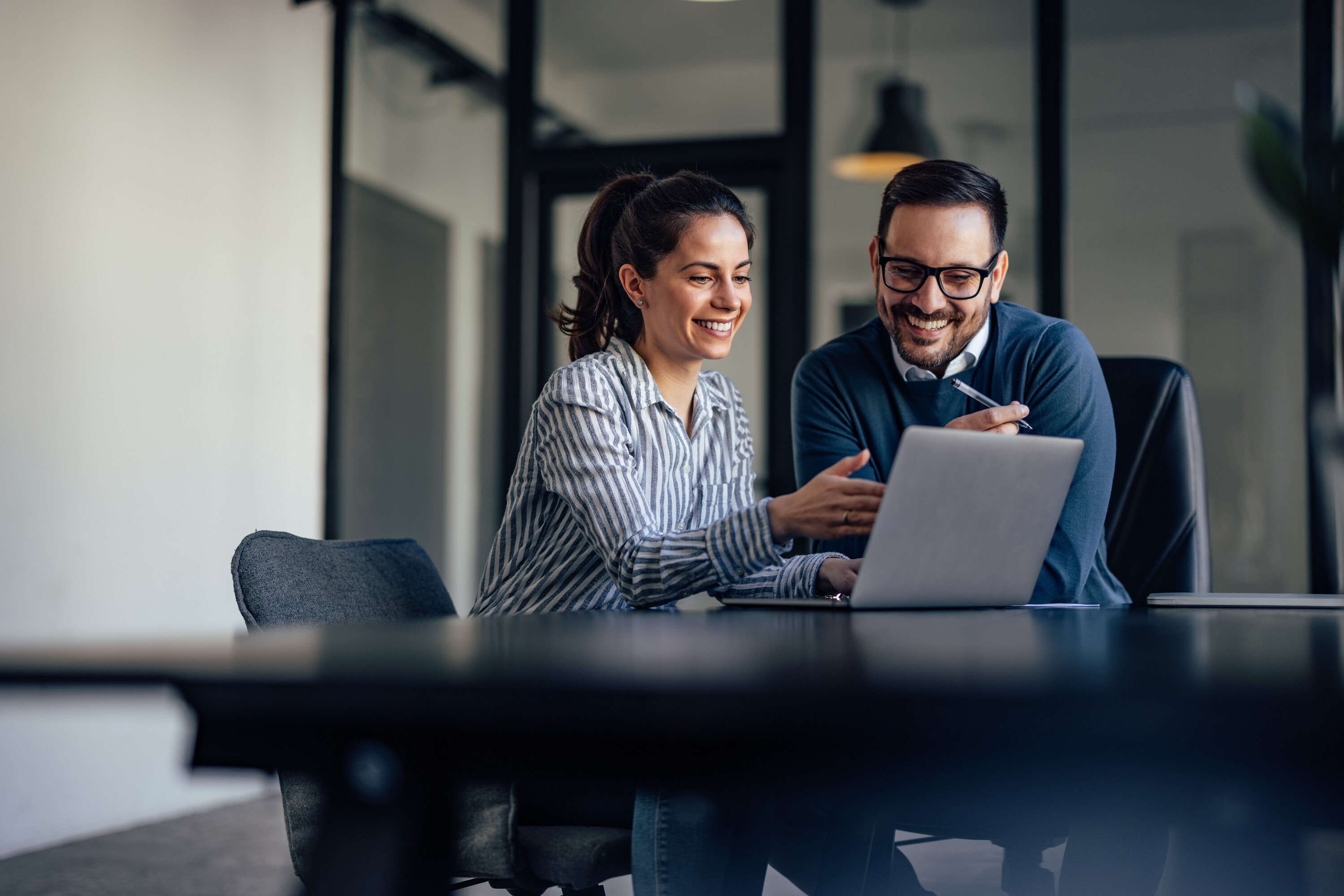 Portrait of two business colleagues, looking at something online